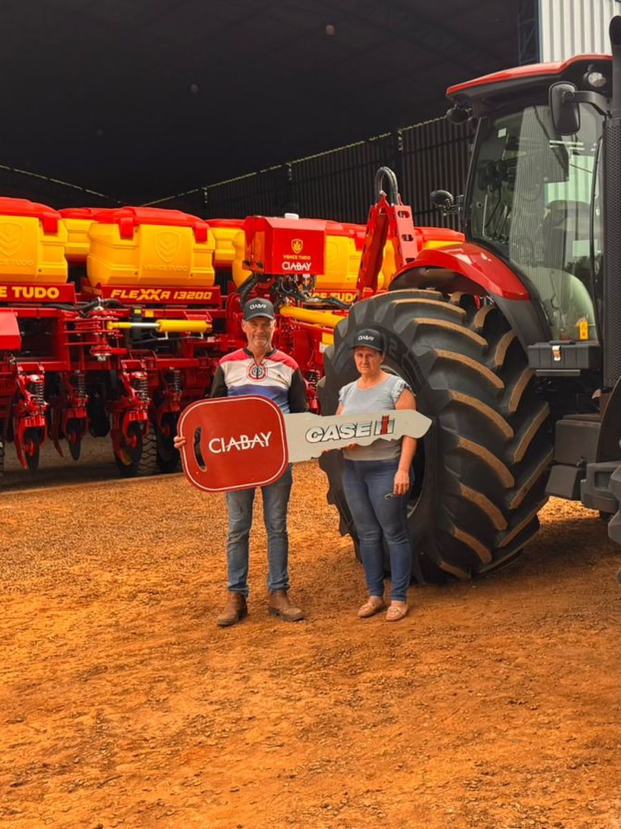 Pareja de clientes con la llave simbólica de CIABAY frente a su nuevo tractor Case IH Puma 200